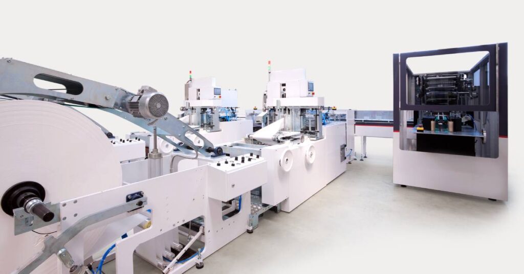 Packaging and printing machines in a warehouse, showing equipment neatly arranged and ready for industrial operation.