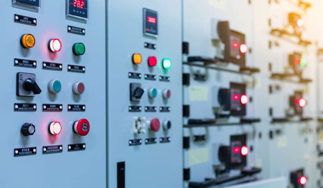 A low voltage motor control center cabinet with lots of lights in a coal power plant, featuring electrical switchgear.